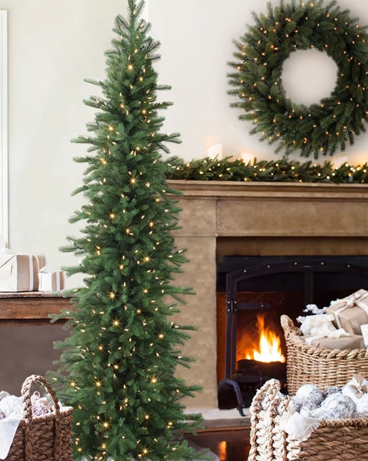 A Tall, Slim Christmas Tree Anchors a Cozy Living Room with Fireplace A Tall, Slim Christmas Tree Anchors a Cozy Living Room with Fireplace — Slim Christmas Tree Decor