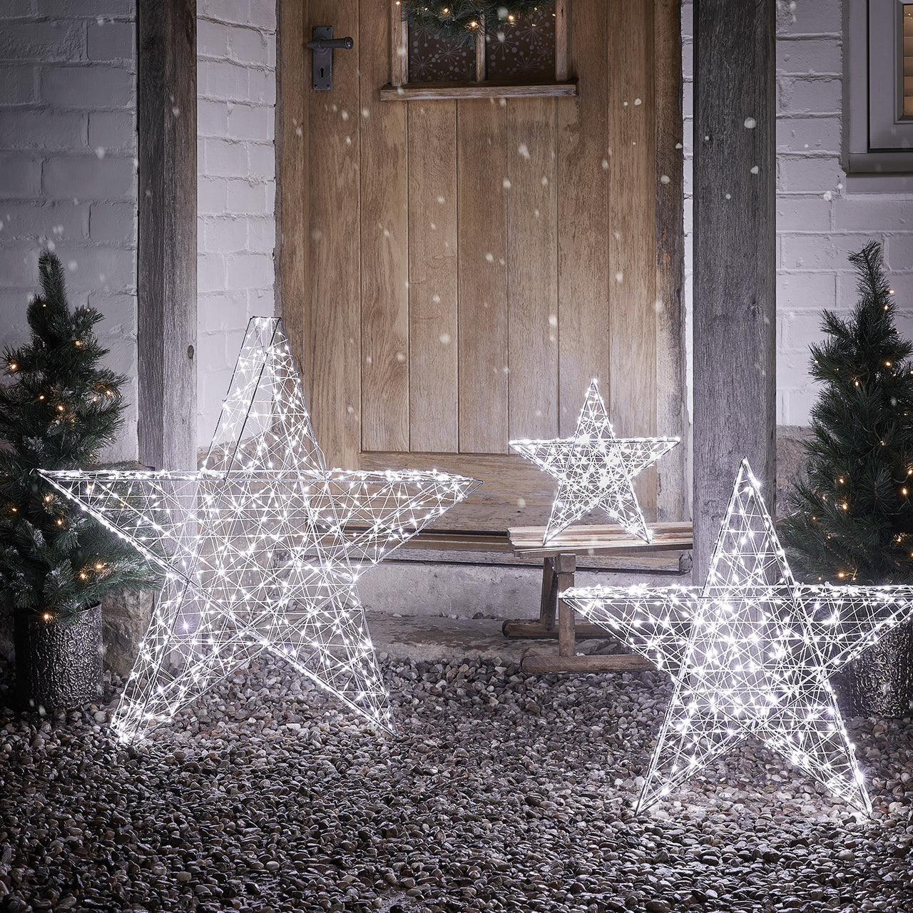Illuminated Wire Stars on a Gravel Porch — Christmas Yard Decor