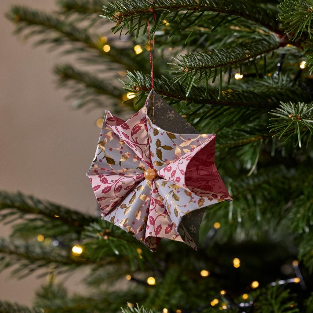 Intricate Origami Ornament on a Tree Branch Intricate Origami Ornament on a Tree Branch — Small Christmas Tree Decor