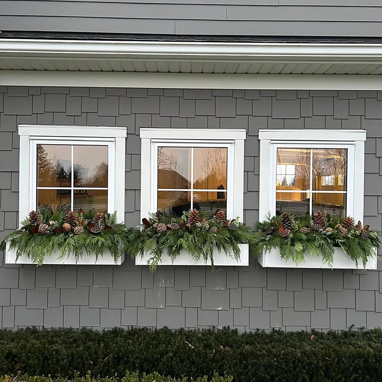 Natural Evergreen Boughs Fill White Window Boxes Natural Evergreen Boughs Fill White Window Boxes — Christmas Window Decor Outdoor