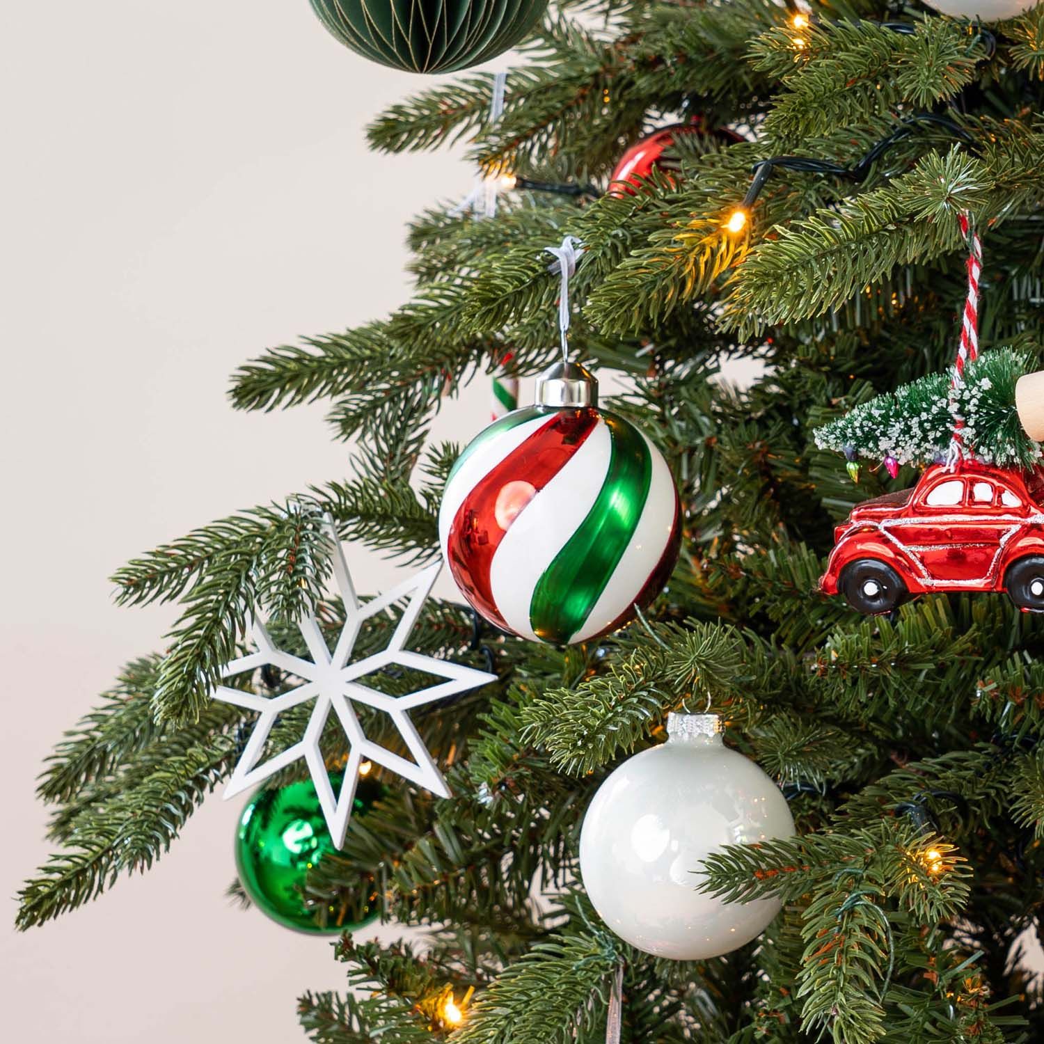 Detail Shot: Red and Green Swirl Bauble on a Christmas Tree Branch Detail Shot: Red and Green Swirl Bauble on a Christmas Tree Branch — Red and Green Christmas Tree