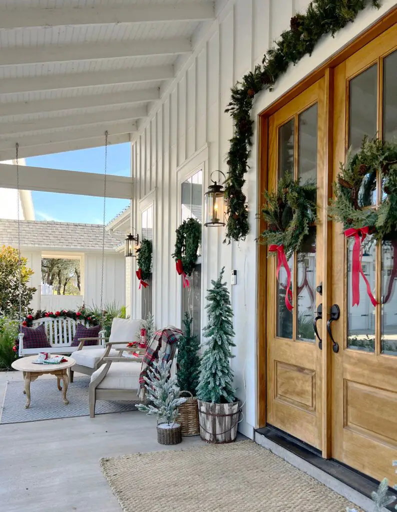 Inviting Farmhouse Porch with Swing Bench and Garland Inviting Farmhouse Porch with Swing Bench and Garland — Farmhouse Christmas Porch