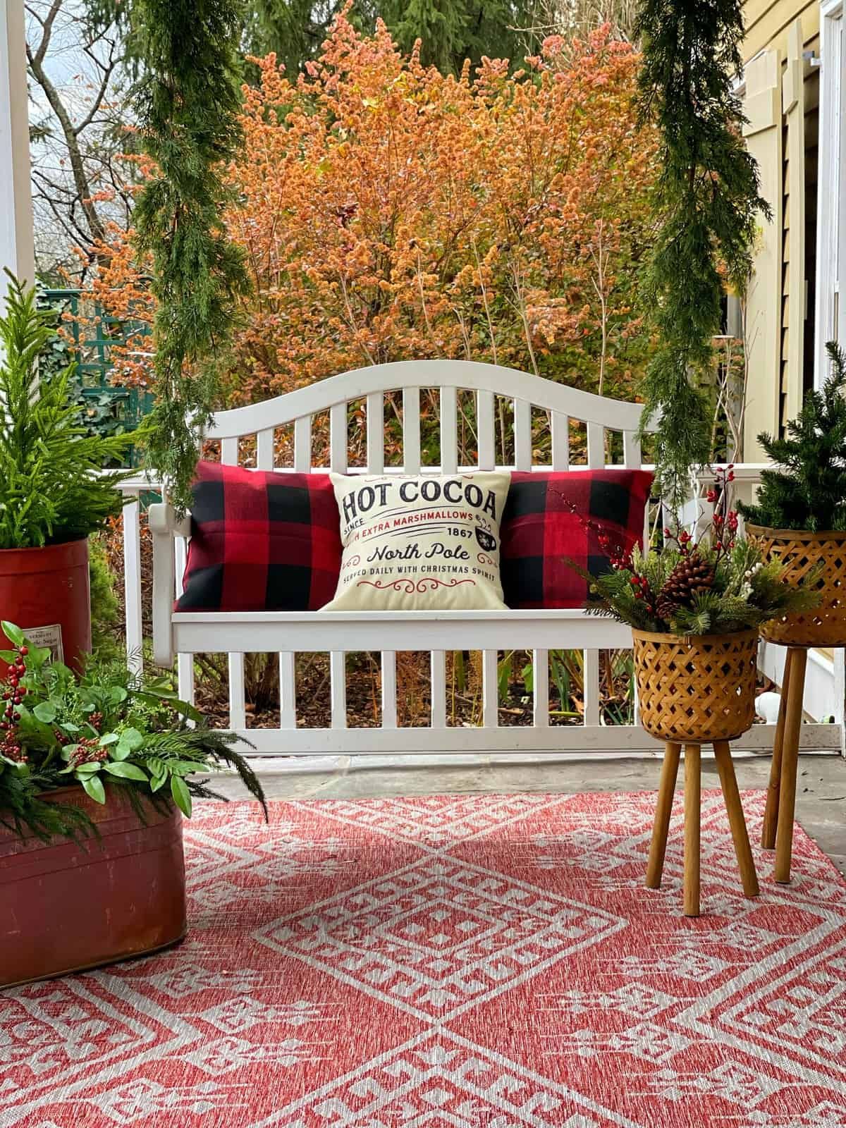 Charming Farmhouse Porch Swing with Buffalo Check Pillows Charming Farmhouse Porch Swing with Buffalo Check Pillows — Farmhouse Christmas Porch