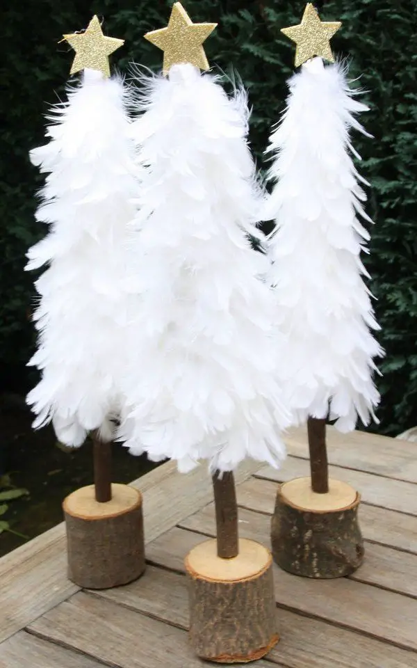 None Outdoor Display of White Feather Trees with Gold Stars None Outdoor Display of White Feather Trees with Gold Stars — White Christmas Tree Decor