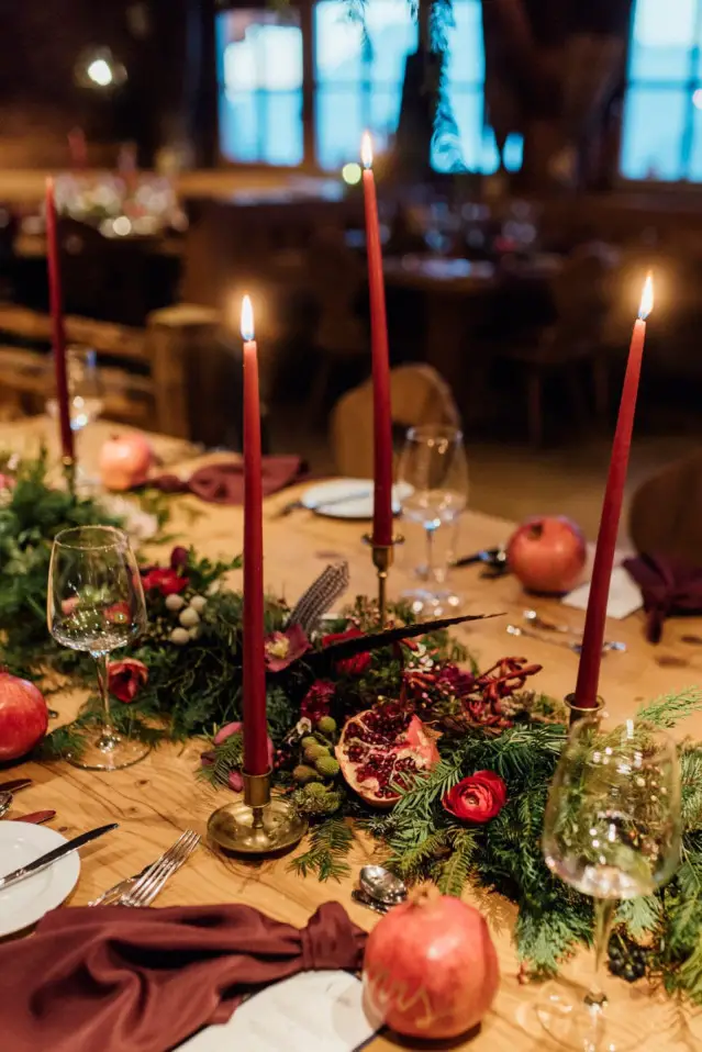 Dramatic Centerpiece with Red Candles, Pomegranates, and Evergreen Garland Dramatic Centerpiece with Red Candles, Pomegranates, and Evergreen Garland — Christmas Wedding Centerpiece