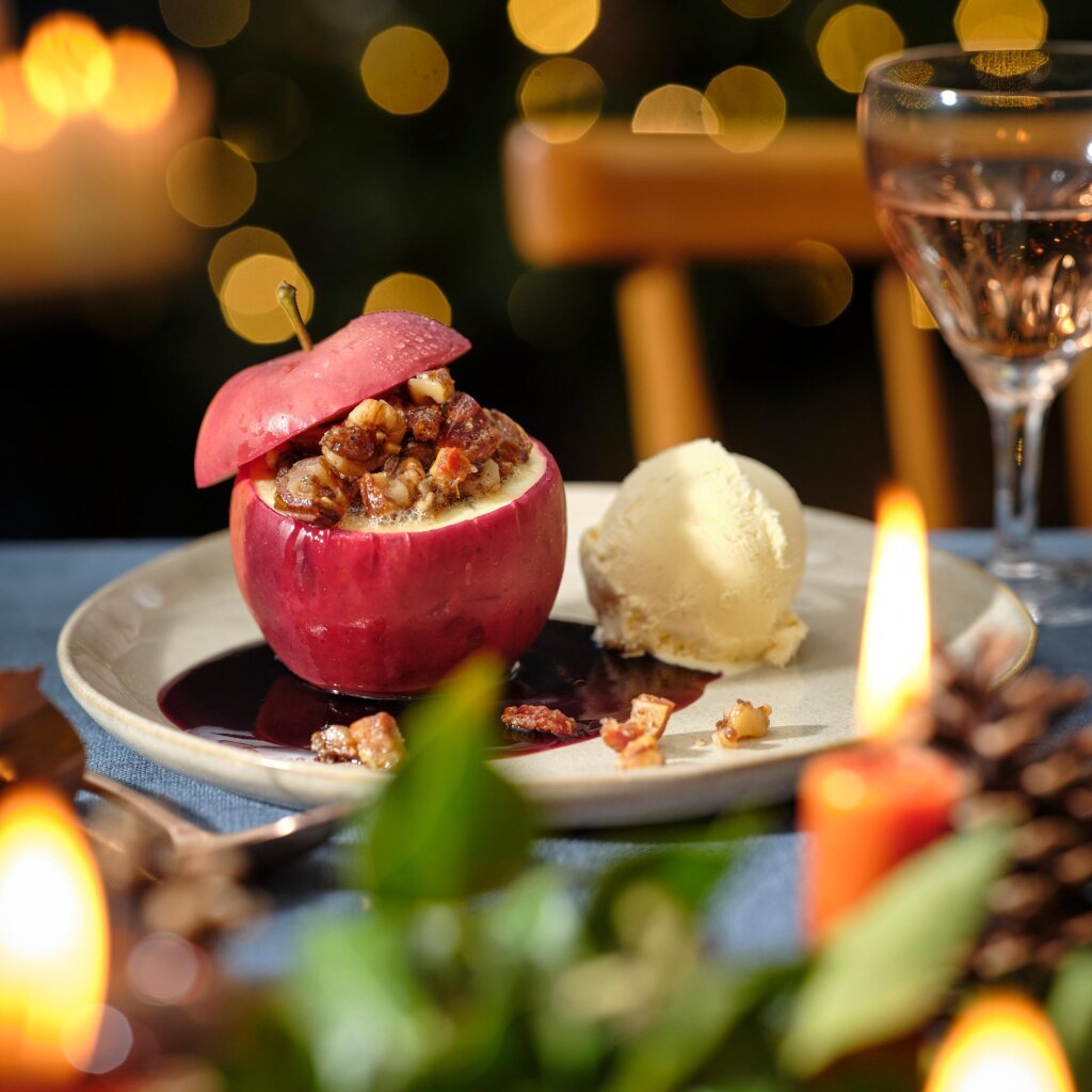Cozy Baked Apple with Ice Cream and Bokeh Lights — Christmas Dessert Table