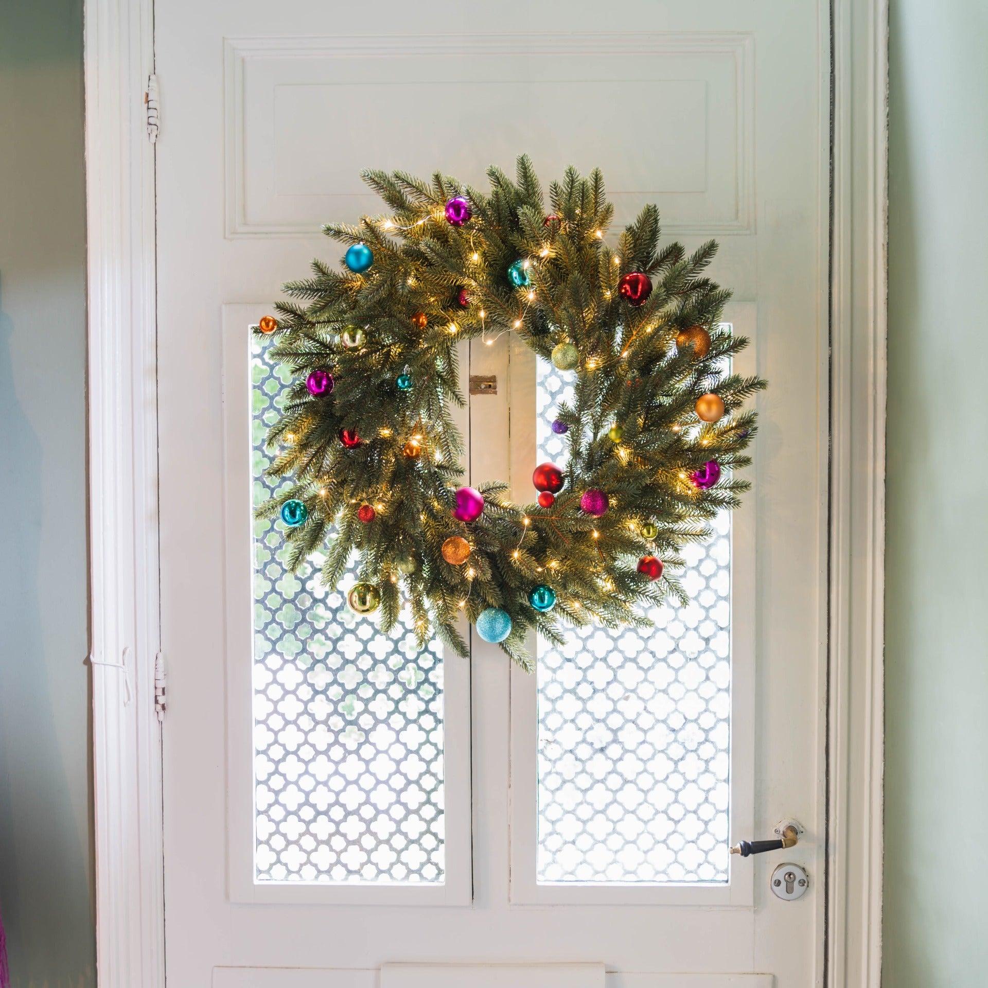 Festive Pine Wreath with Colorful Baubles and String Lights Festive Pine Wreath with Colorful Baubles and String Lights — Christmas Window Wreaths