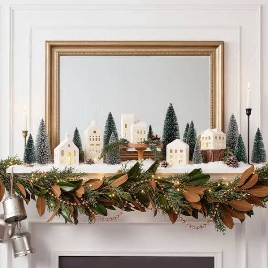 Charming Mantelpiece with Miniature Village and Magnolia Garland — Whimsical Christmas Decor