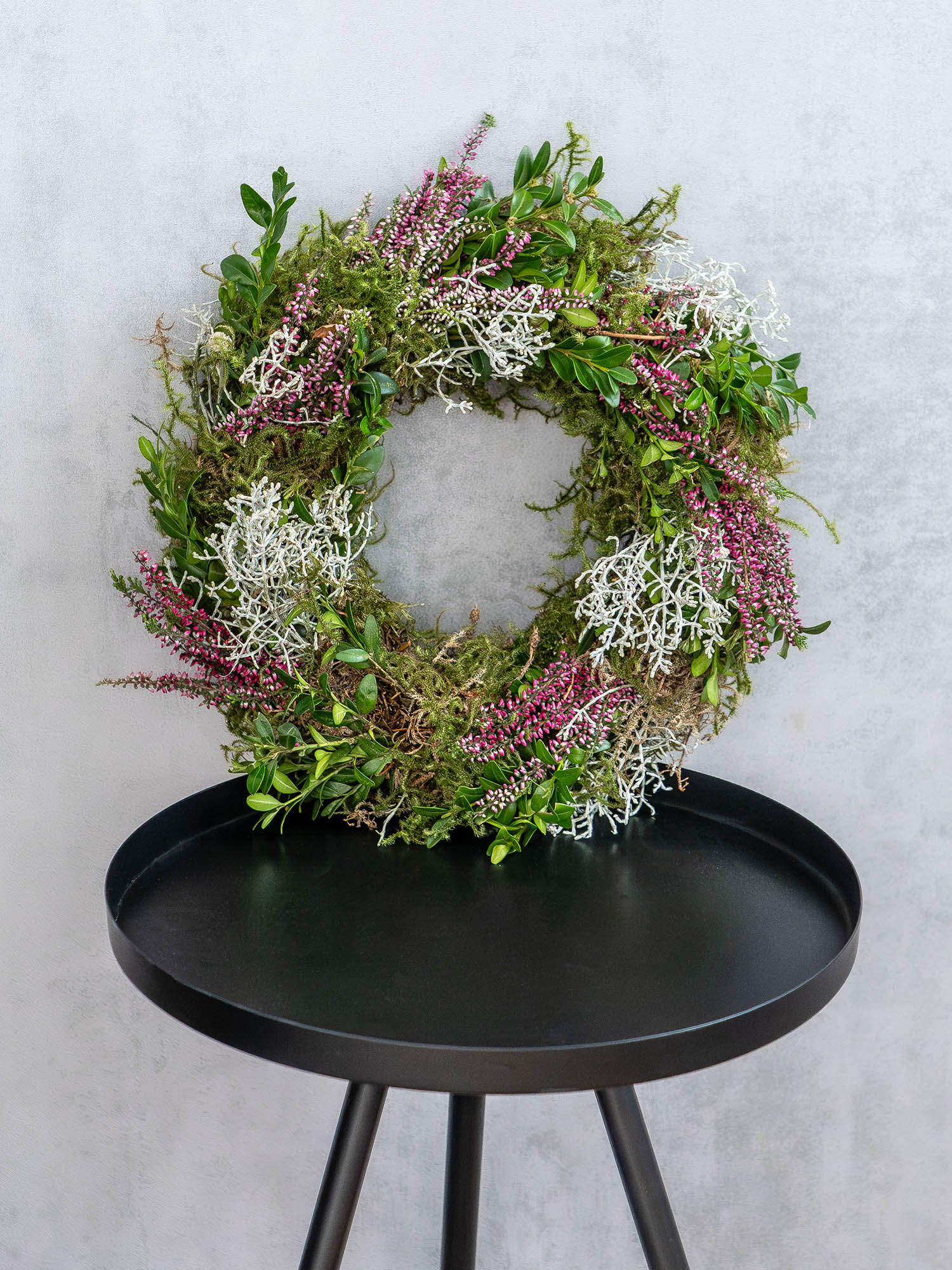 Natural Moss and Heather Wreath on a Black Table Natural Moss and Heather Wreath on a Black Table — Ornament Wreath