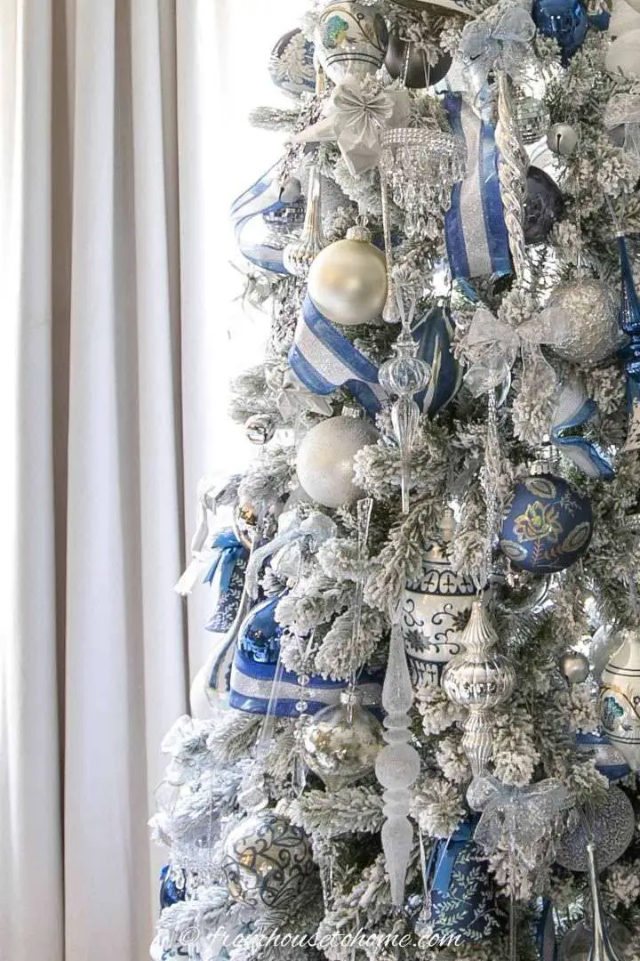 Detailed Blue and White Patterned Ornaments on a Flocked Tree Detailed Blue and White Patterned Ornaments on a Flocked Tree — Flocked Christmas Tree Decor