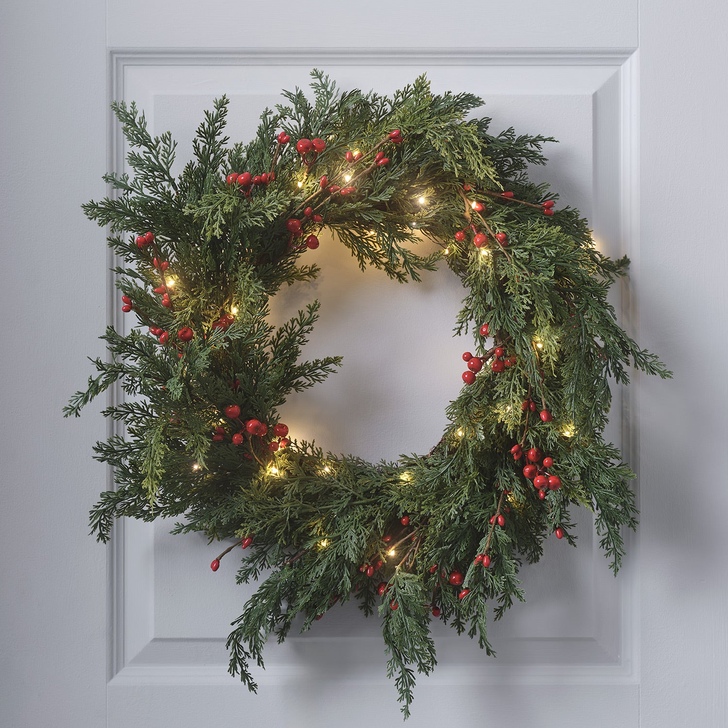 Modern Evergreen Wreath with LED Lights on a Paneled Door Modern Evergreen Wreath with LED Lights on a Paneled Door — Christmas Window Wreaths