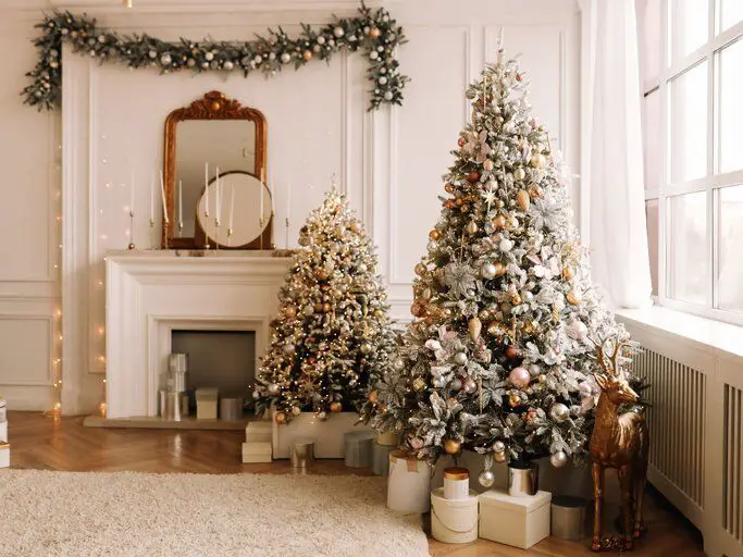 Elegant Flocked White Christmas Trees Flank a Fireplace Elegant Flocked White Christmas Trees Flank a Fireplace — White Christmas Tree Decor