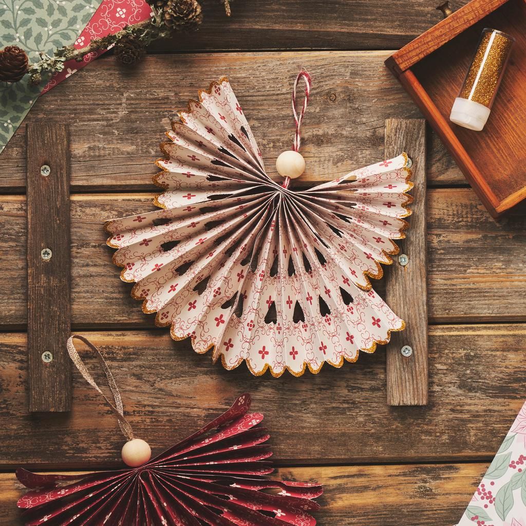 Intricate Paper Fan Ornament on a Tree Intricate Paper Fan Ornament on a Tree — Small Christmas Tree Decor