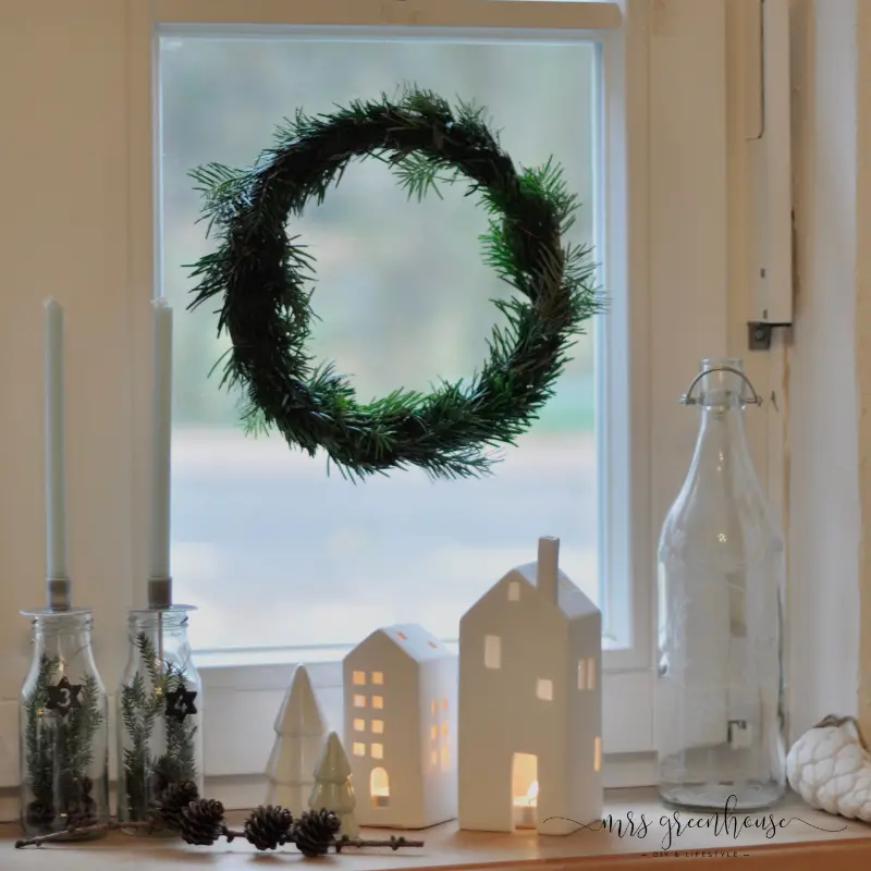 Simple Pine Wreath with Charming Window Sill Lanterns and Pinecones Simple Pine Wreath with Charming Window Sill Lanterns and Pinecones — Christmas Window Wreaths
