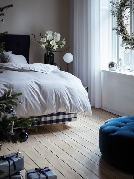 Minimalist Bedroom with Blue Ottoman and Green Wreath — Christmas Bedroom Decor
