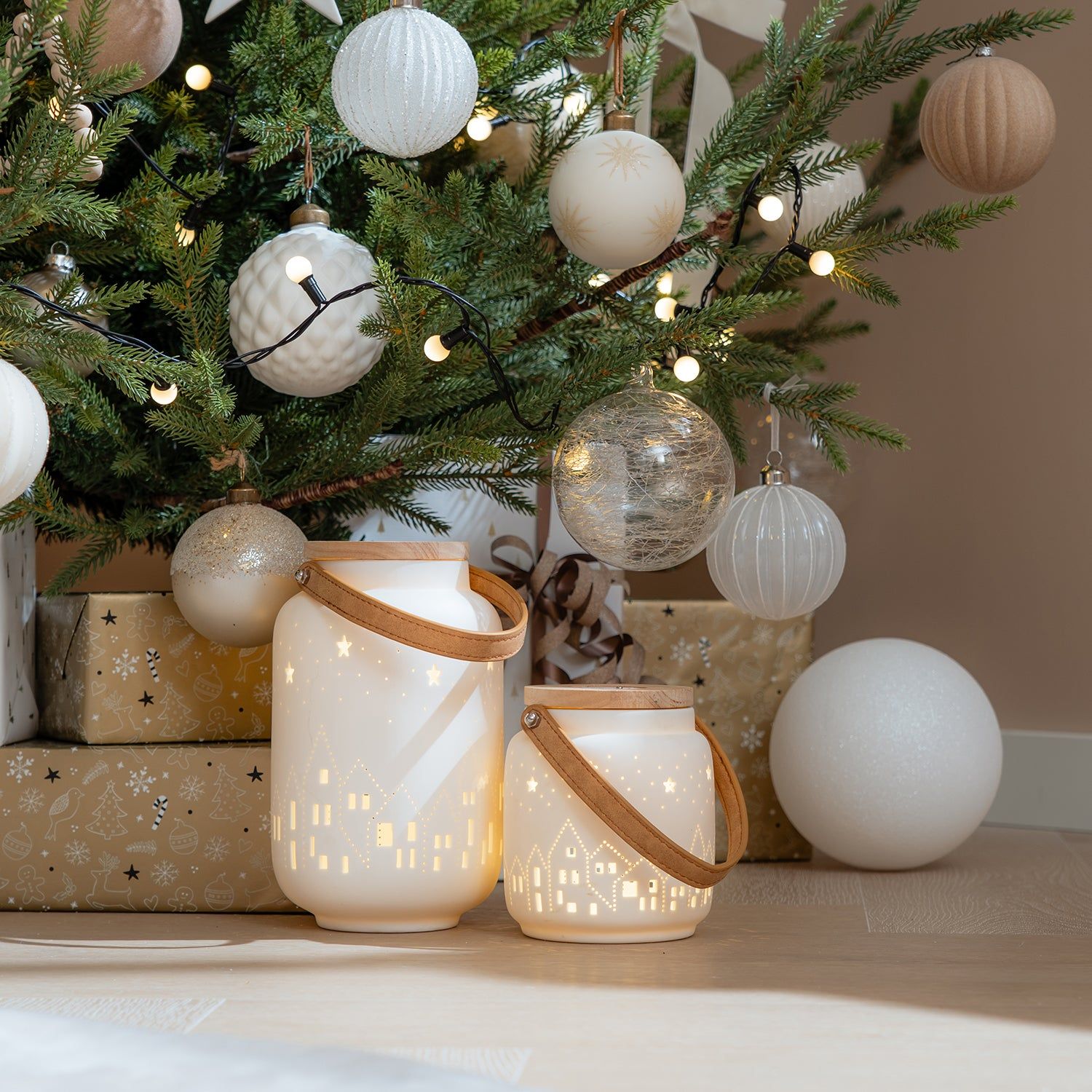 Porcelain Village Lanterns Placed Near Christmas Tree with Gifts — Christmas Lantern Lights