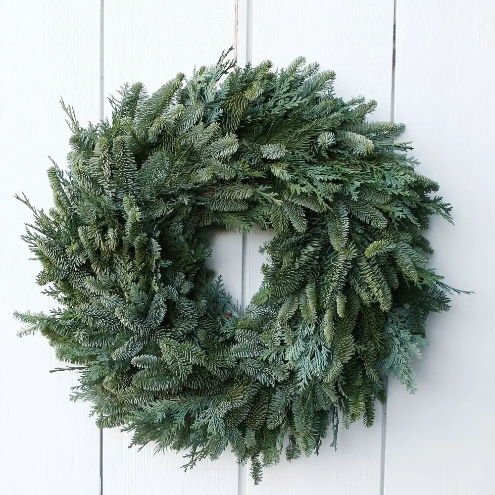 Full Evergreen Wreath on a White Wooden Door Full Evergreen Wreath on a White Wooden Door — Ornament Wreath