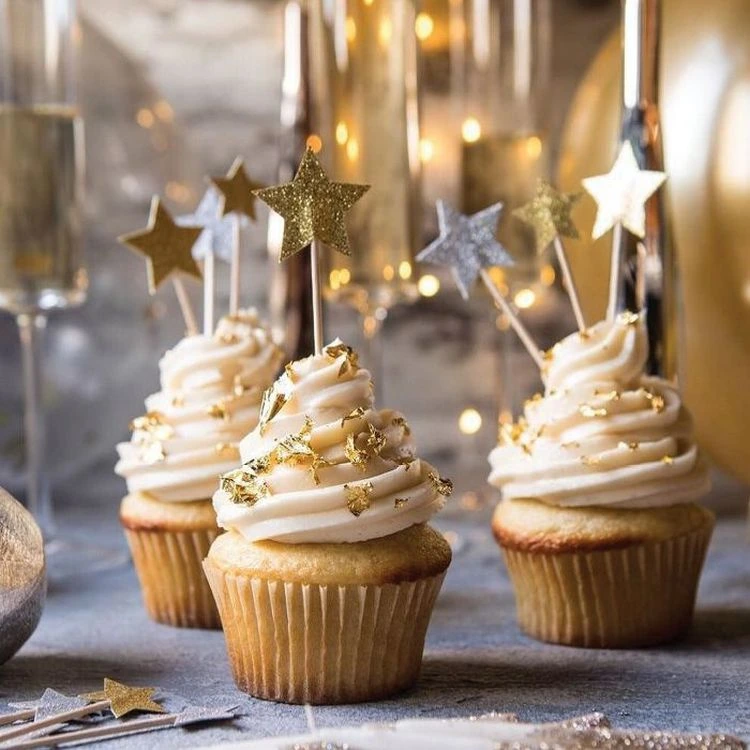 Close-Up of Gold-Dusted Cupcakes with Star Toppers — New Years Eve Dessert Table