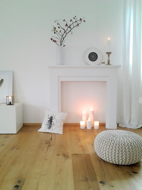 Minimalist Fireplace with Candle Cluster and Natural Elements — Christmas Fireplace Decor