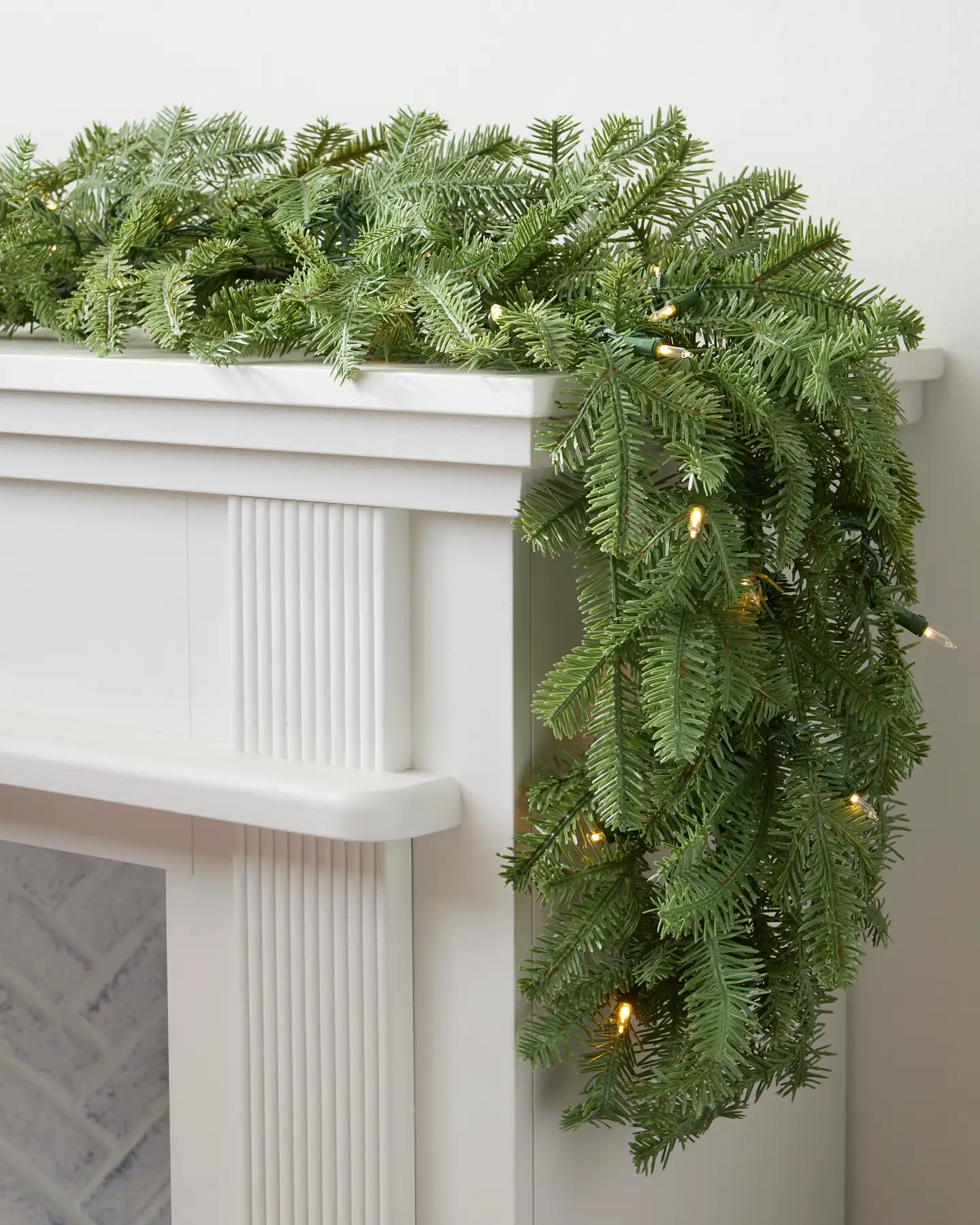 Full Artificial Garland with Integrated String Lights on a Fireplace — Christmas Garland