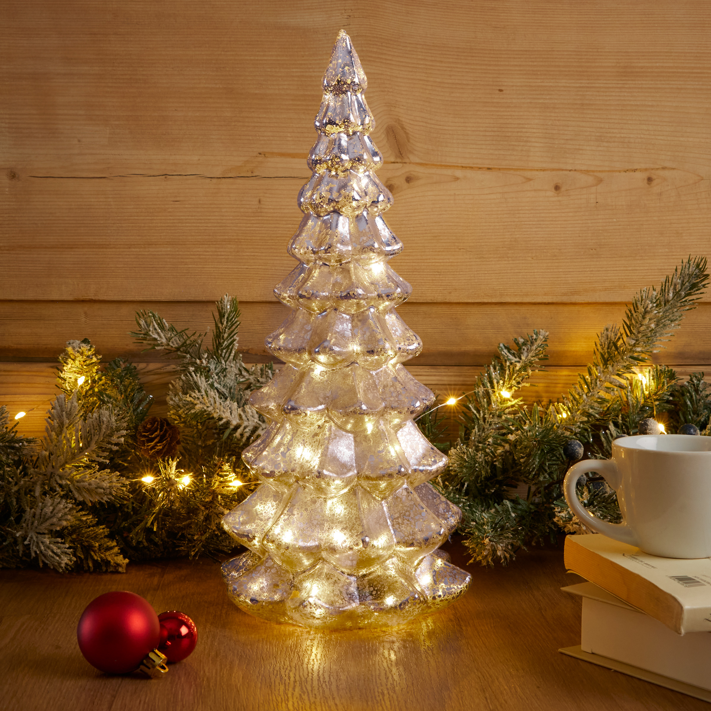 Mercury Glass Tree Glows on Wooden Surface Mercury Glass Tree Glows on Wooden Surface — Christmas Tree Lights