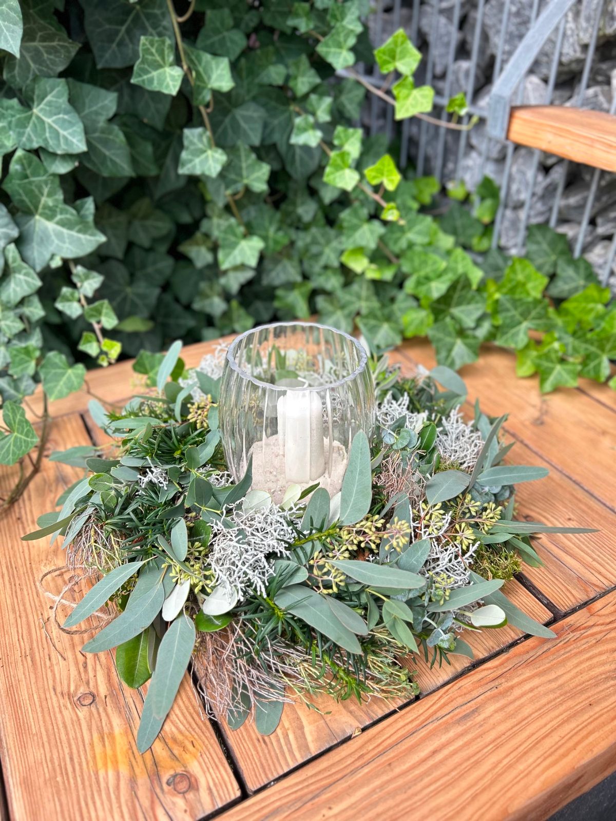 Natural Greenery Wreath Around a Hurricane Candle Holder Natural Greenery Wreath Around a Hurricane Candle Holder — DIY Christmas Wreath