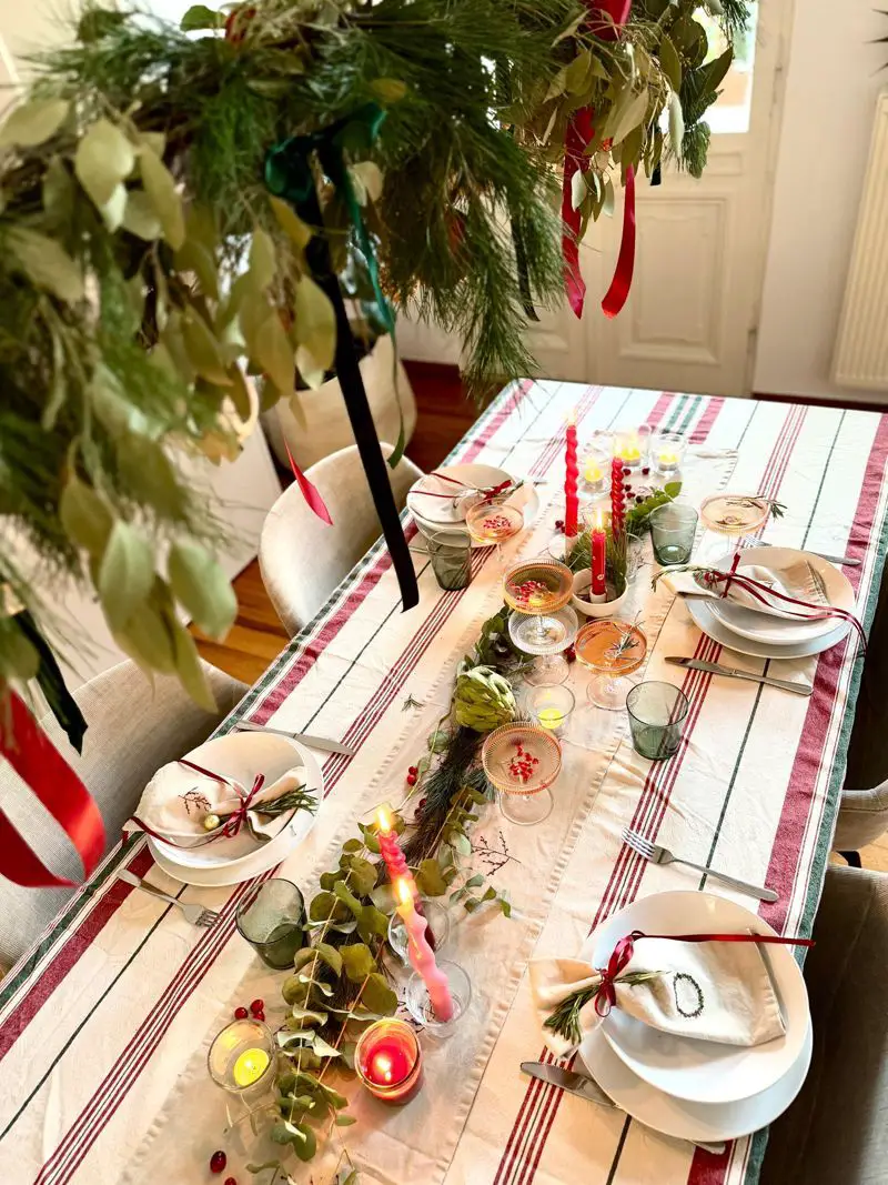 Traditional Dining Room with Striped Tablecloth and Overhead Greenery — Christmas Dining Room Decor