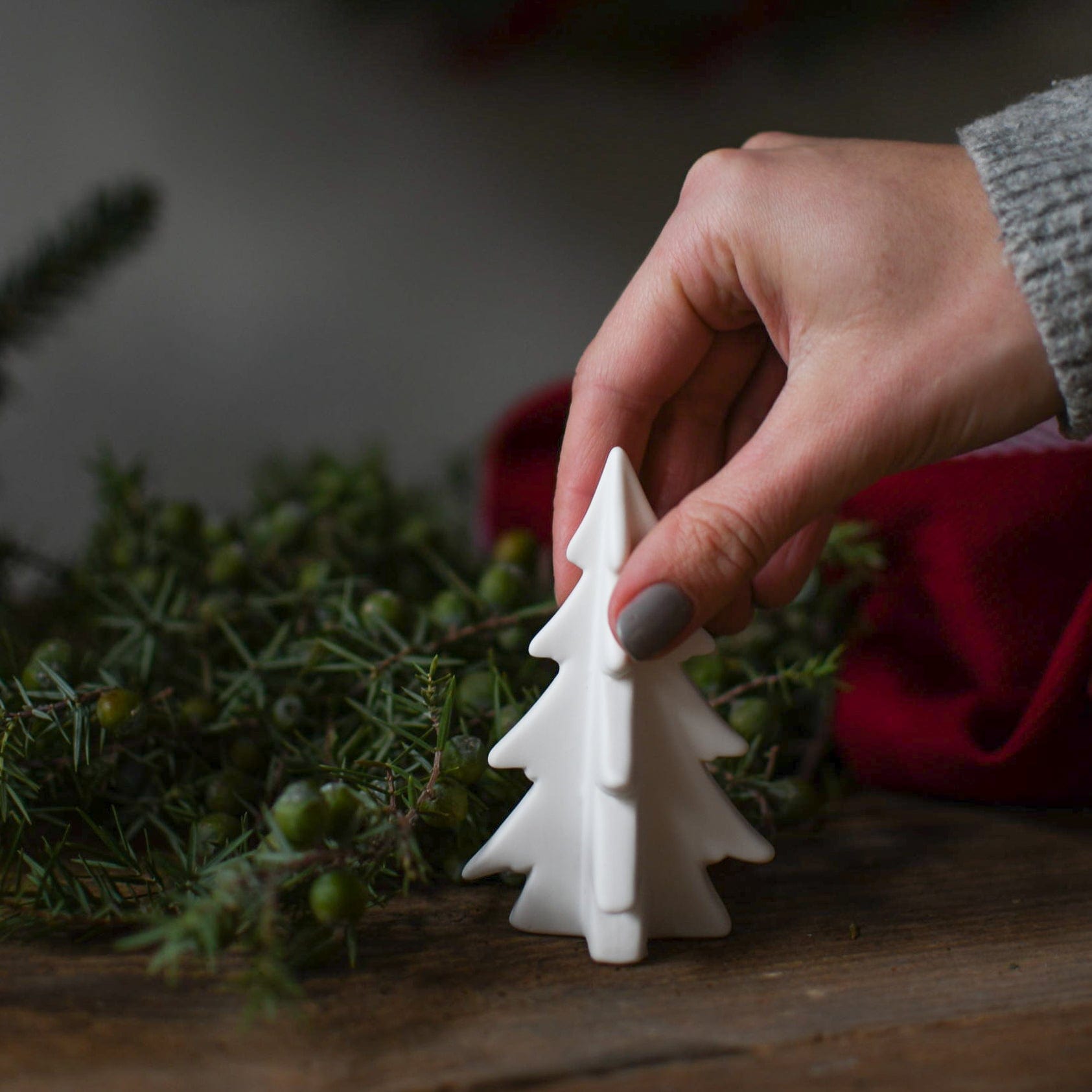 Minimalist White Ceramic Christmas Tree on Wooden Surface Minimalist White Ceramic Christmas Tree on Wooden Surface — Dollar Tree Christmas Decor