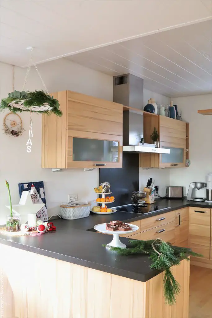 Scandi Kitchen Featuring a Hanging Greenery Wreath and Star Ornaments Scandi Kitchen Featuring a Hanging Greenery Wreath and Star Ornaments — Christmas Kitchen Decor