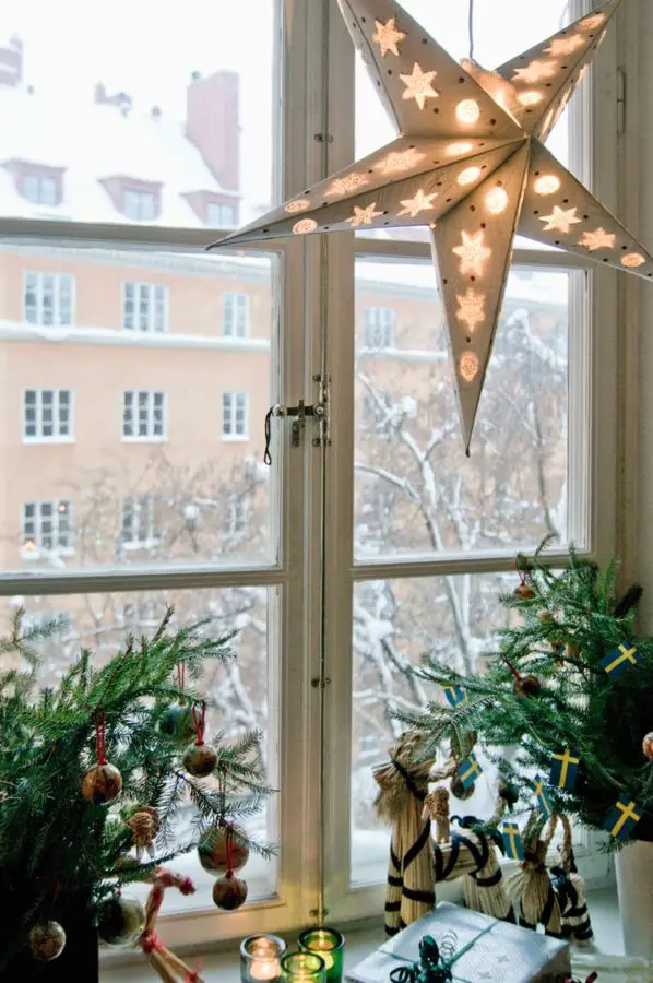 Windowsill Enchanting Paper Star Lantern on a Snowy Window Sill — Traditional Christmas Decor