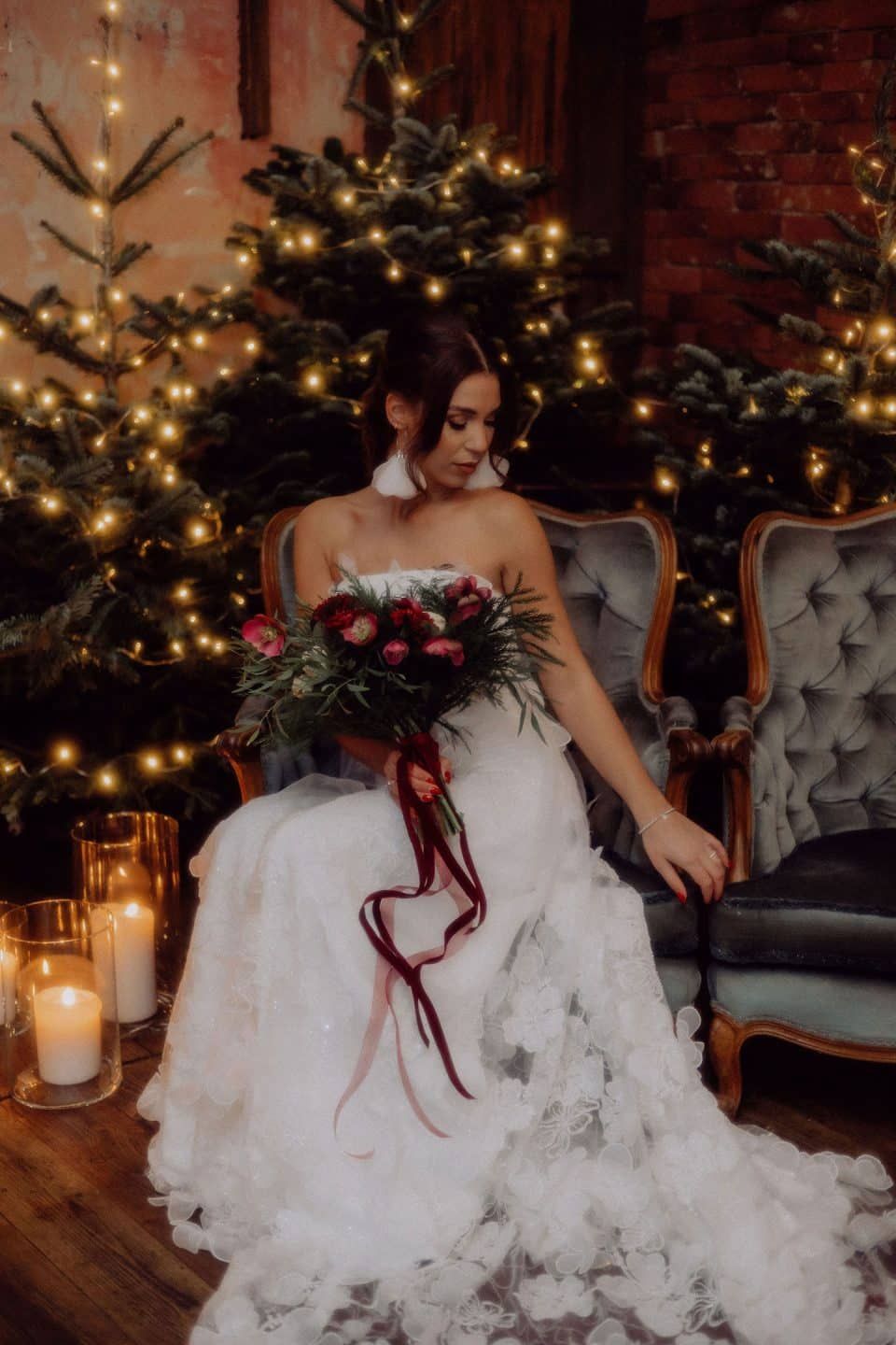 Romantic Glow: Bride Amidst Christmas Trees and Candles — Christmas Wedding Decor