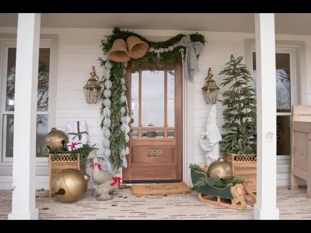 Classic Farmhouse Entrance with Abundant Greenery and Bells Classic Farmhouse Entrance with Abundant Greenery and Bells — Farmhouse Christmas Porch