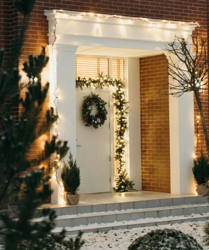 Illuminated Doorway with Garland, Wreath, and Potted Greens Illuminated Doorway with Garland, Wreath, and Potted Greens — Christmas Door Frame Lights
