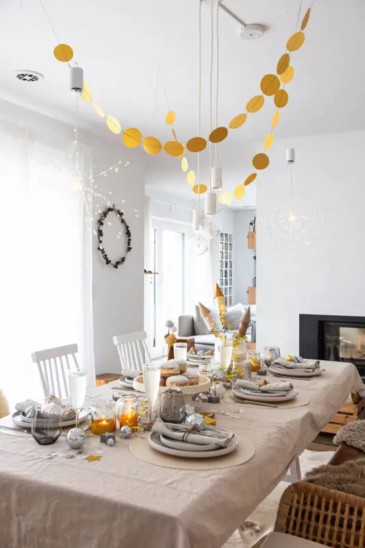 Overhead Gold Garlands and Starburst Lights for Festive Dining — Gold New Years Eve Decor