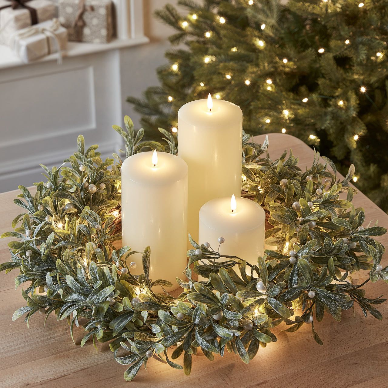 Cream LED Pillar Candles in a Mistletoe Wreath Centerpiece — Christmas Candle Decor