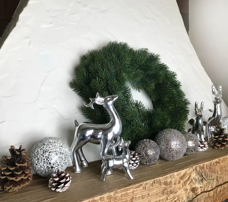 Minimalist White Fireplace with Green Wreath and Deer Figures — Christmas Fireplace Decor