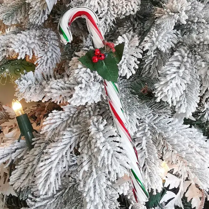 Sparkling Glass Candy Cane on a Flocked Tree Sparkling Glass Candy Cane on a Flocked Tree — Candy Cane Christmas Decor