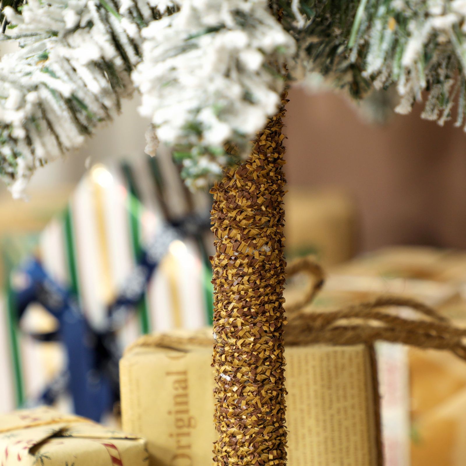 Pencil Flocked Tree Base with Brown Paper Wrapped Gifts Pencil Flocked Tree Base with Brown Paper Wrapped Gifts — Flocked Christmas Tree Decor