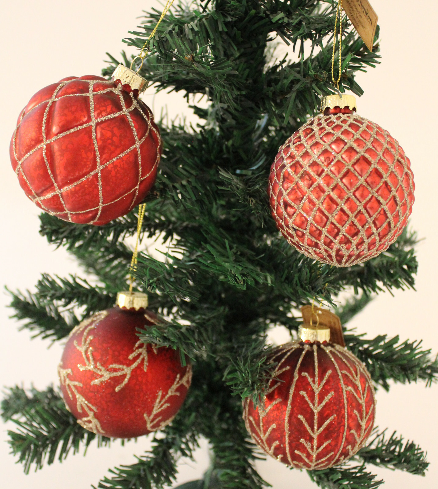 Small Artificial Christmas Tree with Red Ornaments and Gold Glitter Small Artificial Christmas Tree with Red Ornaments and Gold Glitter — Red and Gold Christmas Tree