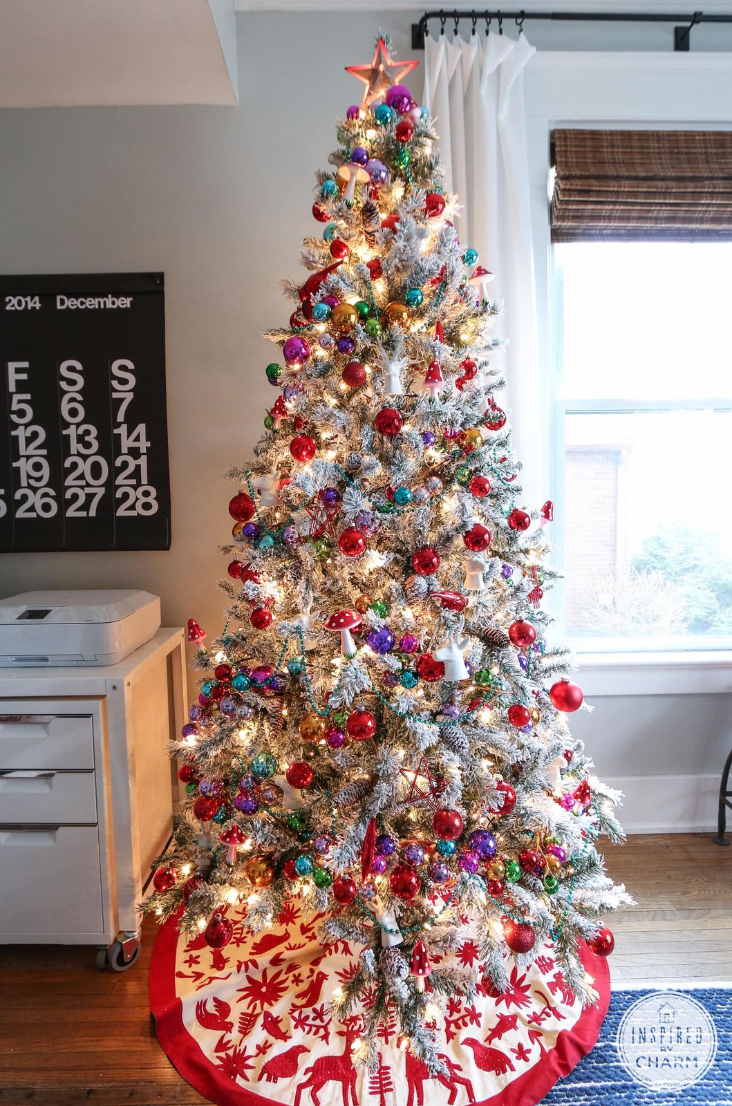 Tall Flocked Tree with Colorful Ornaments and Festive Skirt Tall Flocked Tree with Colorful Ornaments and Festive Skirt — Flocked Christmas Tree Decor