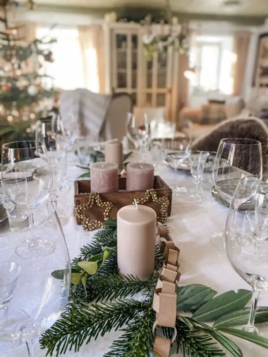 Scandinavian Dining Table with Blush Pillar Candles and Greenery — Christmas Candle Decor