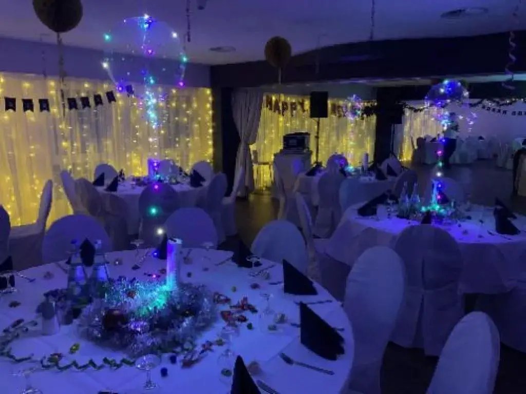 Illuminated Balloons and White Draped Tables — New Years Eve Party 2027