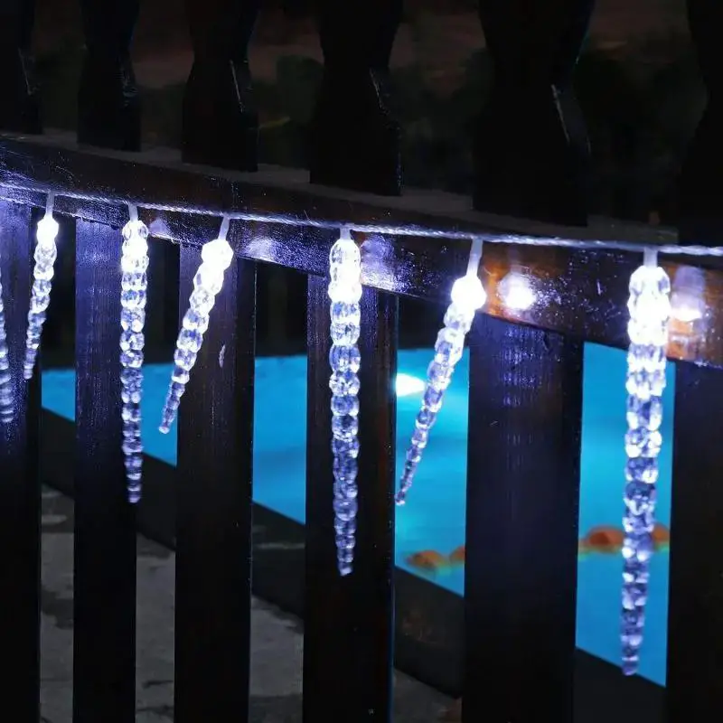 Festive Border Along a Dark Wooden Fence Festive Border Along a Dark Wooden Fence — Icicle Christmas Lights