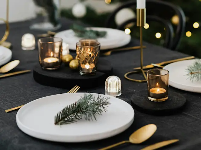 Modern Gold Cutlery and Pine Sprigs on White Plates Modern Gold Cutlery and Pine Sprigs on White Plates — New Years Eve Table Decor