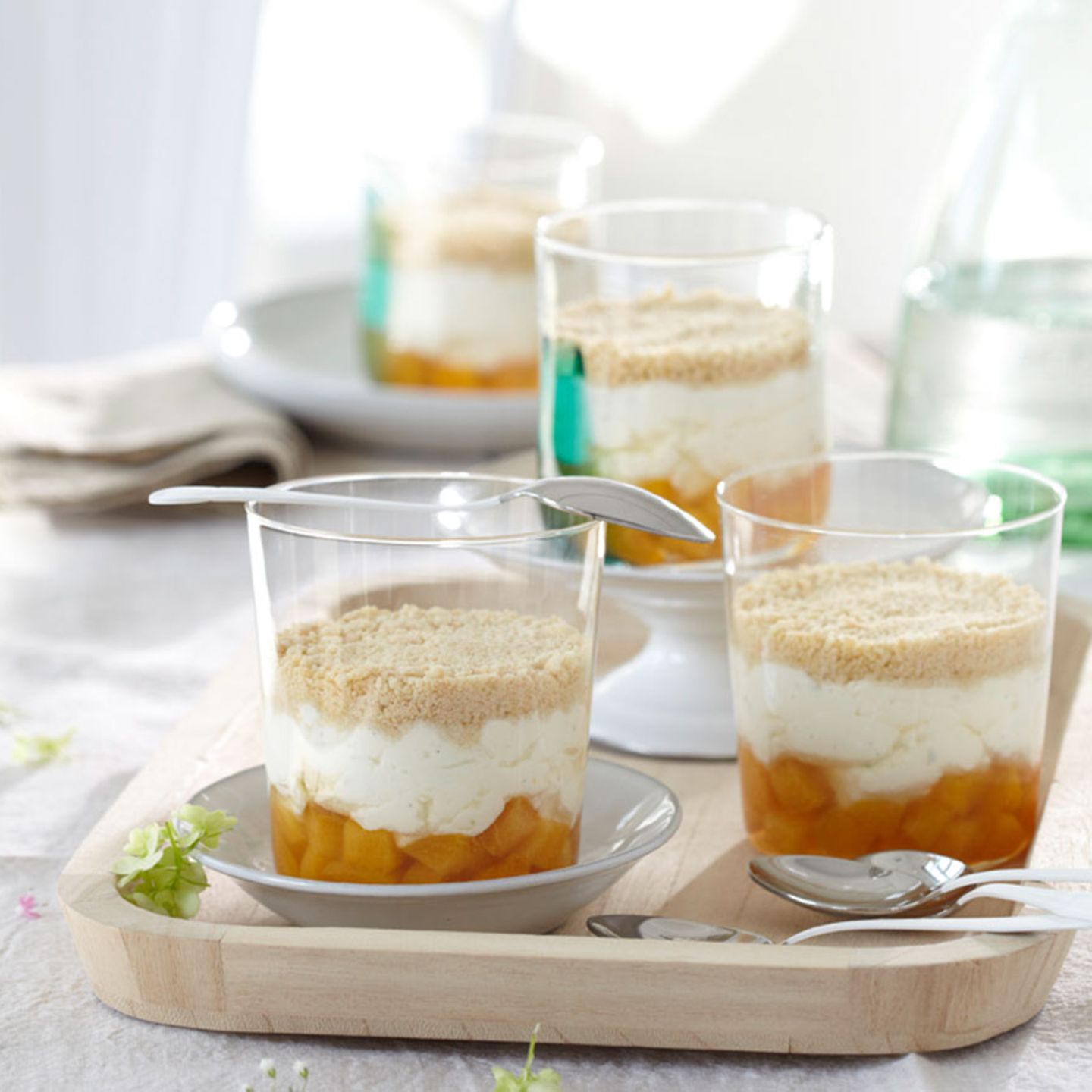 Layered Desserts with Peach and Crumble Topping on a Wooden Tray — New Years Eve Dessert Table