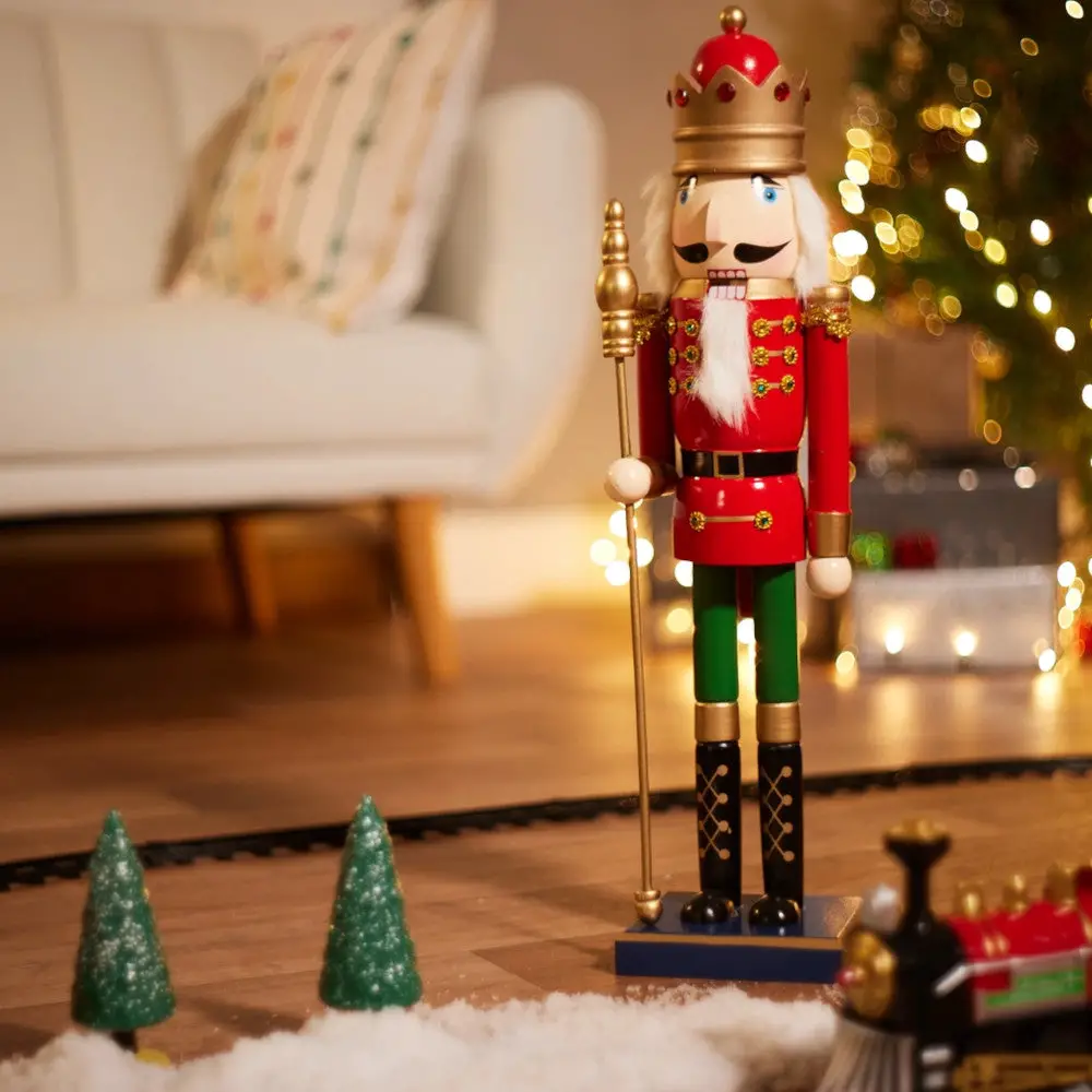 Playful King Nutcracker with Toy Train on Snowy Floor Playful King Nutcracker with Toy Train on Snowy Floor — Nutcracker Christmas Tree