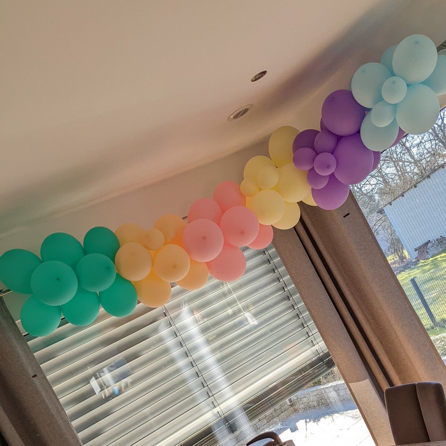 Vibrant Pastel Balloon Garland Draped Across a Ceiling — New Years Eve Balloon Garland