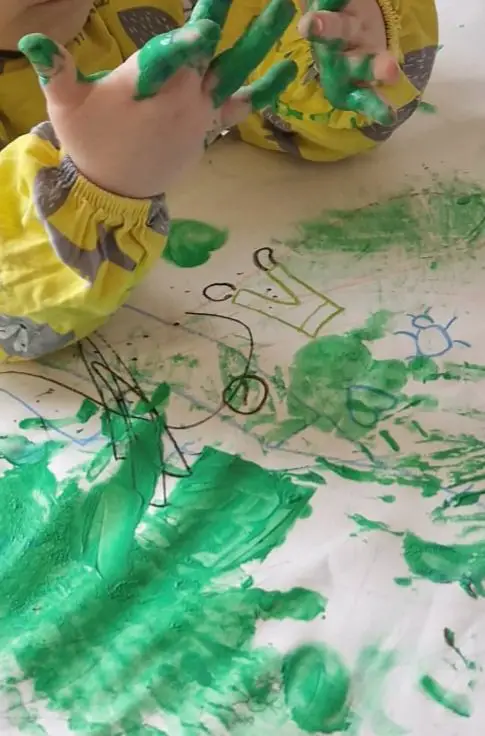 Child's Hands Covered in Green Paint — Christmas Crafts for Kids