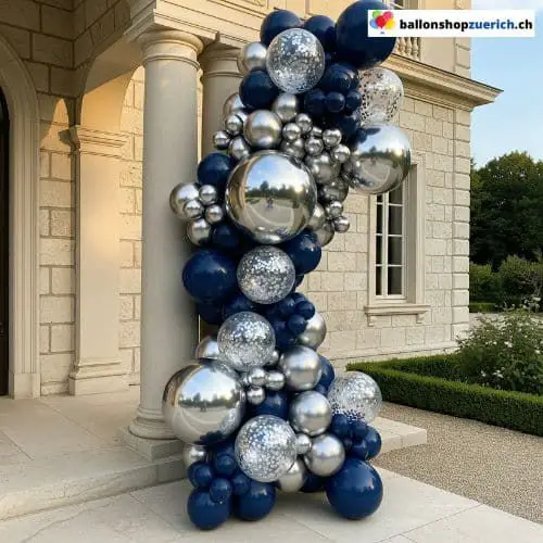 Striking Navy Blue and Silver Balloon Garland Cascading Down Outdoor Pillar — New Years Eve Balloon Garland