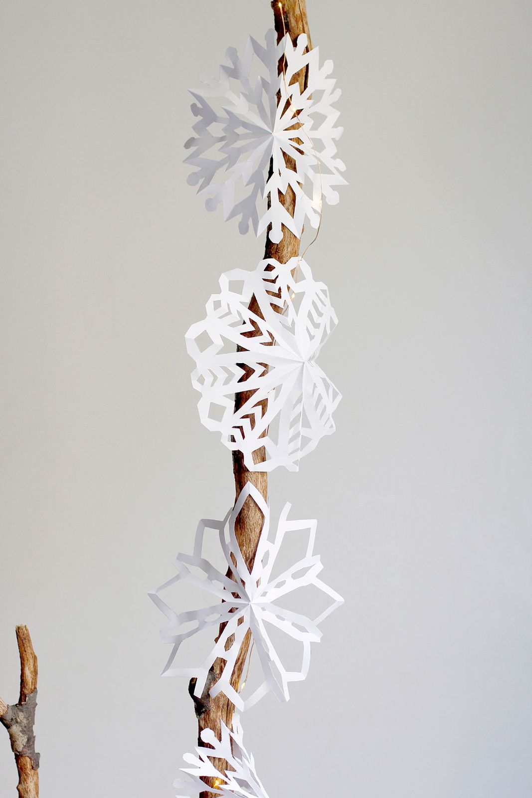 Paper Snowflake Garland on a Natural Branch — Paper Snowflakes
